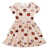 Blake Birdie Dress by Birdie Bean in bamboo viscose, cake pattern with chocolate and vanilla cakes, short sleeves, ruffled hem.