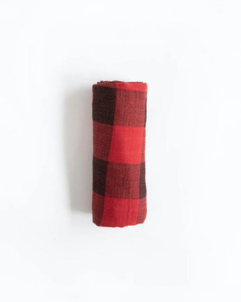 A folded Little Unicorn Red Plaid Cotton Swaddle on a plain white background.