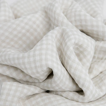 Close-up of beige and white gingham cotton from LouLou Lollipops Farmyard Swaddle Set, showing soft folds perfect for breathable blankets.