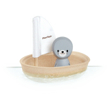 PlanToys Sailing Boat, Seal includes a gray seal in a wooden boat with a white sail. Sustainable fun on the water!.