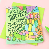 Turtle Soups Turtley Awesome birthday card features a turtle with gifts on recycled paper. Text: Have a Turtley Awesome Birthday!.