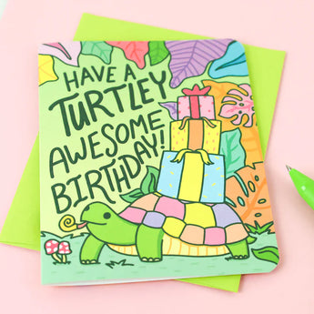 Turtle Soups Turtley Awesome birthday card features a turtle with gifts on recycled paper. Text: Have a Turtley Awesome Birthday!.