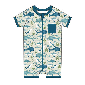 Emerson and Friends Shark Friends romper features whales, seaweed, short sleeves, teal trim, and a front pocket in soft bamboo.
