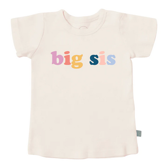 The Finn and Emma Organic Tee, Big Sis is cream-colored, featuring a playful big sis print, made with organic cotton and eco-friendly dyes.
