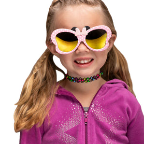 A girl wears Sunstaches Lil Characters Minnie Mouse Pink sunglasses and a purple glitter jacket, ideal for Disney fans.