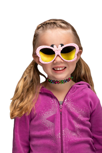 A girl wears Sunstaches Lil Characters Minnie Mouse Pink sunglasses and a purple glitter jacket, ideal for Disney fans.