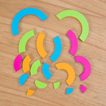 The Bugzzle Game by Fat Brain Toy Co uses colorful geometric shapes in green, blue, pink, and orange for a math challenge on wood.