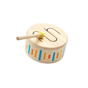 The PlanToys Solid Drum II is a sustainably made wooden instrument with colorful vertical lines and a wavy pattern.