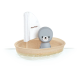 Discover the eco-friendly PlanToys Sailing Boat, Seal: a sustainable toy with PlanWood, featuring a gray seal figure and white sail.