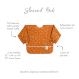 Infographic of Bumkins Sleeved Bib: Bumkins signature waterproof fabric, full sleeves, adjustable tie neck closure, catch-all pocket.