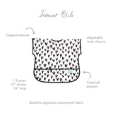 Bumkins Junior Bib: Hearts features capped sleeves, stain-resistant fabric, adjustable neck closure, and catch-all pocket for ages 1-3.
