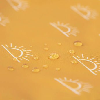 Close-up of water droplets on a yellow Bumkins Reusable Snack Bag, Large 2-Pack: Sunshine and Grounded.