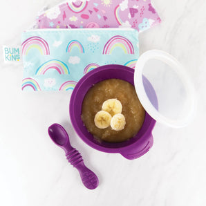 Bumkins Silicone First Feeding Set: Purple bowl with suction, includes purple spoon & rainbow pouches; perfect for applesauce & banana slices.