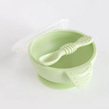 Bumkins Silicone First Feeding Set: Sage includes a suction base bowl, matching spoon, and translucent lid on a white background.