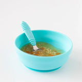 Bumkins Silicone Grip Bowl: Blue holds soup with pasta and a matching spoon on a white background.