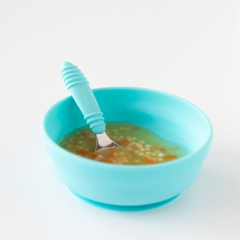 Bumkins Silicone Grip Bowl: Blue holds soup with pasta and a matching spoon on a white background.