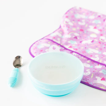 Bumkins Silicone Grip Bowl: Blue with a transparent lid, a blue spoon, and purple patterned bib on a white background.