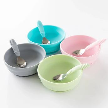 Four bowls with spoons, including Bumkins Silicone Grip Bowl: Sage, are arranged neatly on a white background.