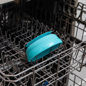 Bumkins Silicone Grip Bowl: Blue sits in the top rack of an open dishwasher.