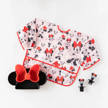 A sleeved bib, silicone dish, and utensils from Bumkins Disney Little Ones Gift Bundle: Minnie Mouse Classic on a white background.