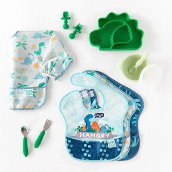 Bumkins Ultimate Gift Set - Dinosaurs & Blue Tropic includes two kinds of bibs, a bowl with spoon, two sets of utensils, and a dinosaur dish.