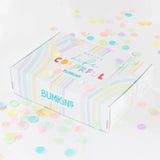 A colorful gift box for Bumkins Ultimate Gift Set - Dinosaurs & Blue Tropic surrounded by confetti on a white background.
