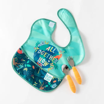 A jungle-themed bib and orange utensils from Bumkins Ultimate Gift Set - Jungle & Animal Prints lay on a white background.