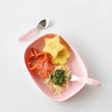 Bumkins Silicone Grip Tray: Pink holds pineapple, red pepper slices, and pesto spaghetti with pink utensils on a white background.