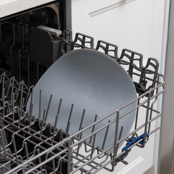 Bumkins Silicone Sensory Placemat: Gray sits in the top rack of an open dishwasher.