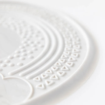 Close-up of Bumkins Silicone Sensory Placemat: Marble on a white background.