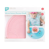 Bumkins Silicone Sensory Placemat: Pink is shown in a packaging box with a photo of a child and a front window partially showing the placemat.