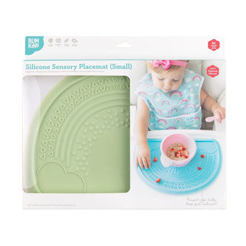 Bumkins Silicone Sensory Placemat: Sage is shown in a packaging box with a photo of a child and a front window partially showing the placemat.