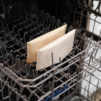 Bumkins Reusable Snack Bag, Small 2-Pack: Sunshine and Grounded sits in the top rack of an open dishwasher.