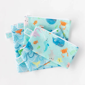 Bumkins Reusable Snack Bag, Small 2-Pack: Ocean Life & Whale Tail lays on top of other similar bags on a white background.