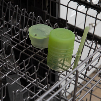 Bumkins Silicone Straw Cup with Lid: Sage sits in the top rack of an open dishwasher.