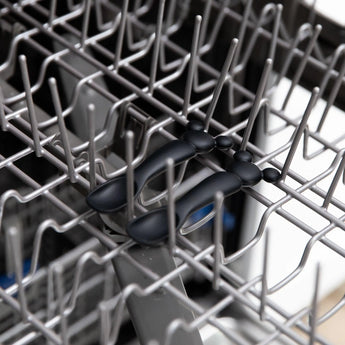 Bumkins Silicone Dipping Spoons: Mickey Mouse (Classic Black) sit on the top rack of an open dishwasher.