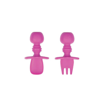 Bumkins Silicone Chewtensils® in Fuchsia: a spoon and fork designed for baby-led weaning on a white background.