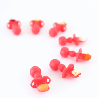 Bumkins Silicone Chewtensils®: Red, ideal for baby-led weaning, are displayed on a white surface.