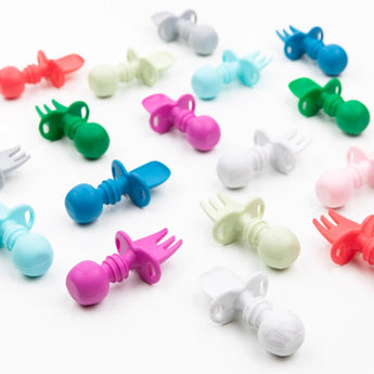 Bumkins Silicone Chewtensils®, vibrant fuchsia spoon-fork combos with pacifier handles, are perfect for safe feeding.