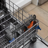 Bumkins Spoon + Fork: Clay sits in the utensil compartment of an open dishwasher.