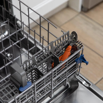 Bumkins Spoon + Fork: Clay sits in the utensil compartment of an open dishwasher.