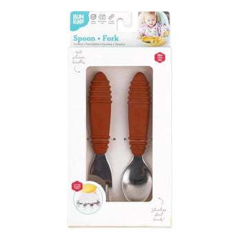 Bumkins Spoon + Fork: Clay is shown in a white packaging box with a clear front window displaying the set of utensils.