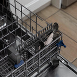 Bumkins Spoon + Fork: Sand sits in the utensil compartment of an open dishwasher.