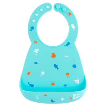 Bumkins Silicone Bib: Ocean Life is made of blue silicone and adorned with sea creatures like jellyfish and whales.