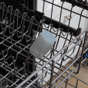 Bumkins Silicone Starter Cup: Gray sits in the top rack of an open dishwasher.
