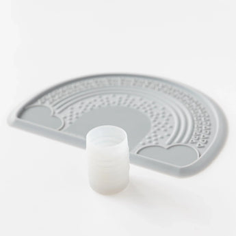 Bumkins Silicone Starter Cup: Gray sits in front of a gray silicone placemat on a white background.