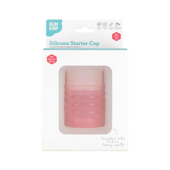 Bumkins Silicone Starter Cup: Pink is shown in a white packaging box, with a front window displaying the cup.