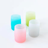 Four cups, including Bumkins Silicone Starter Cup: Pink, sit on a white background.