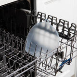 A CPSIA-compliant Grip Dish Silicone Stretch Lid by Bumkins, securely placed in a transparent dishwasher rack.