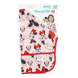 Bumkins Sleeved Bib: Minnie Mouse - pink, red-trimmed, with pocket. Ideal for weaning. Features waterproof design and child model on packaging.